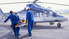 Air ambulance crew taking patient aboard