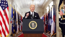 President Biden speaks at podium in White House
