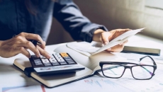 Person with calcualtor and papers