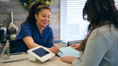 Person signing form at medical office