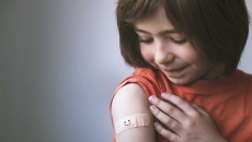 Person with bandage on upper arm