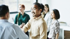 People greet in a sunny room. Photo: Thomas Barwick/Getty Images
