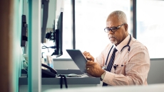 Doctor looking at computer tablet