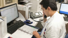 Healthcare professional  on the phone at a desk