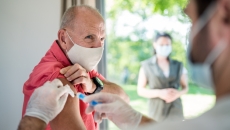 Person wearing a face mask getting a vaccine