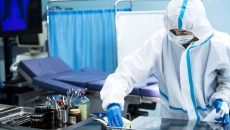 Person in PPE in hospital room