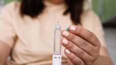 Person holds injection pen