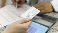 Patient handing over insurance card