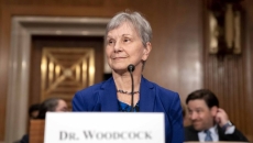Acting FDA Commissioner Janet Woodcock sitting at a microphone