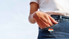 Person wearing rainbow heart pin