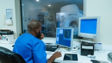 Healthcare worker controlling an MRI machine