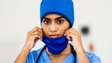 A healthcare professional wears a mask.