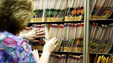 Person at shelves of medical records