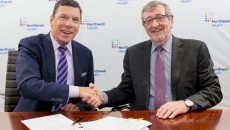 From left, John M. Murphy, MD, president and CEO of Nuvance Health, shakes hands with Northwell president and CEO Michael Dowling at a signing ceremony.