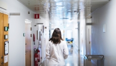 Medical professional in hospital corridor. Photo: Johner Images/Getty Images