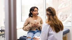 A patient talks with her doctor in the office.