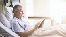 Patient in bed with computer tablet