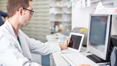 Pharmacist at computer screen