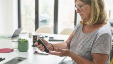 Person at table examining phone
