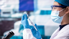Doctor fills syringe in lab setting