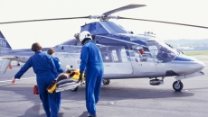 People bringing someone onto an air ambulance