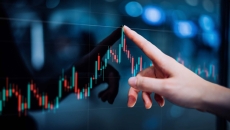 Finger points to graph on screen