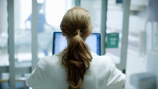 Health professional at computer screen