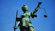 Bronze statue of Justice with scales and sword