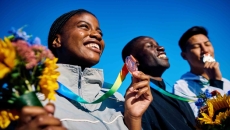 Olympic athletes smiling on winners' podium