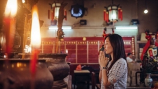 Person praying in religious setting