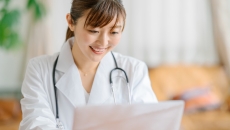 physician looking at paperwork