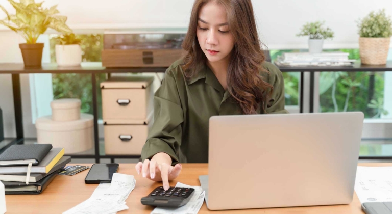 Woman on computer making calculations