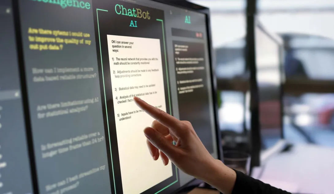 Finger at touchscreen labeled ChatBot AI Finger at touchscreen labeled ChatBot AI