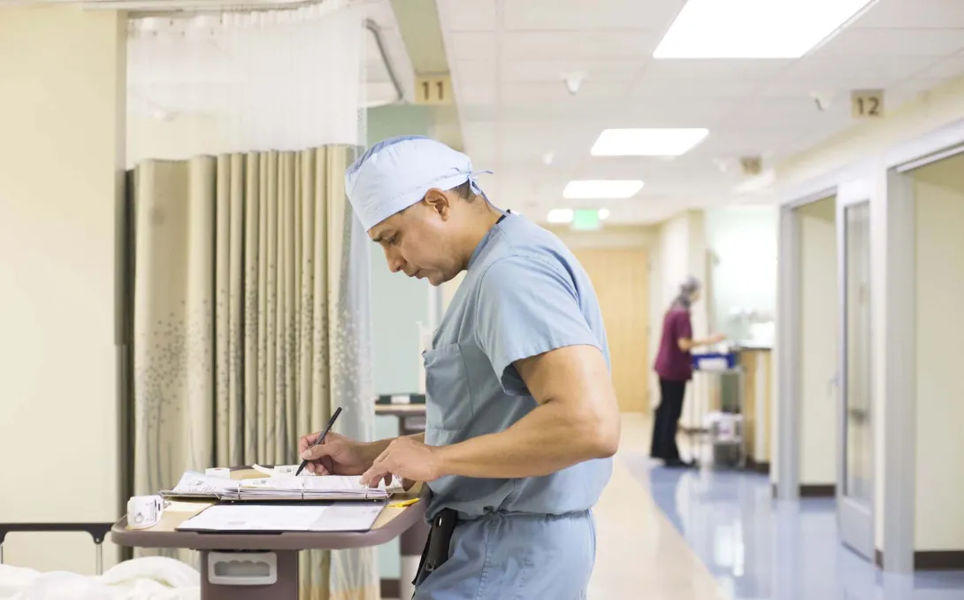 Surgeon looking at notes