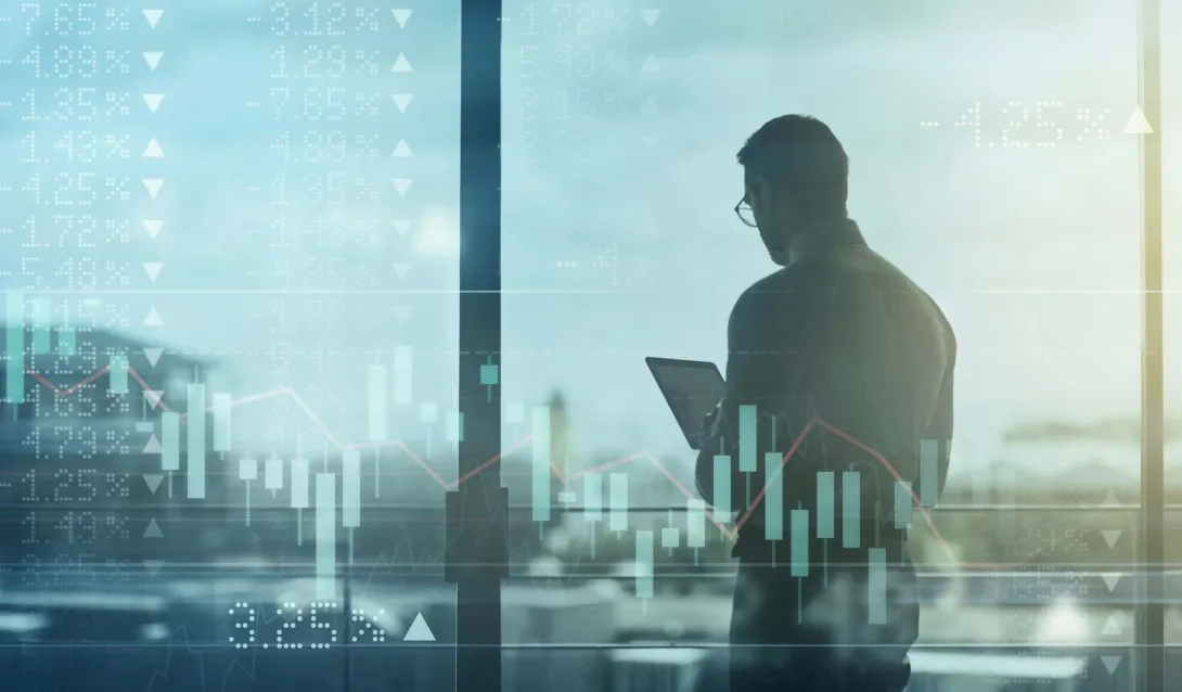 Business person using tablet over shifting stock market image Business person using tablet over shifting stock market image