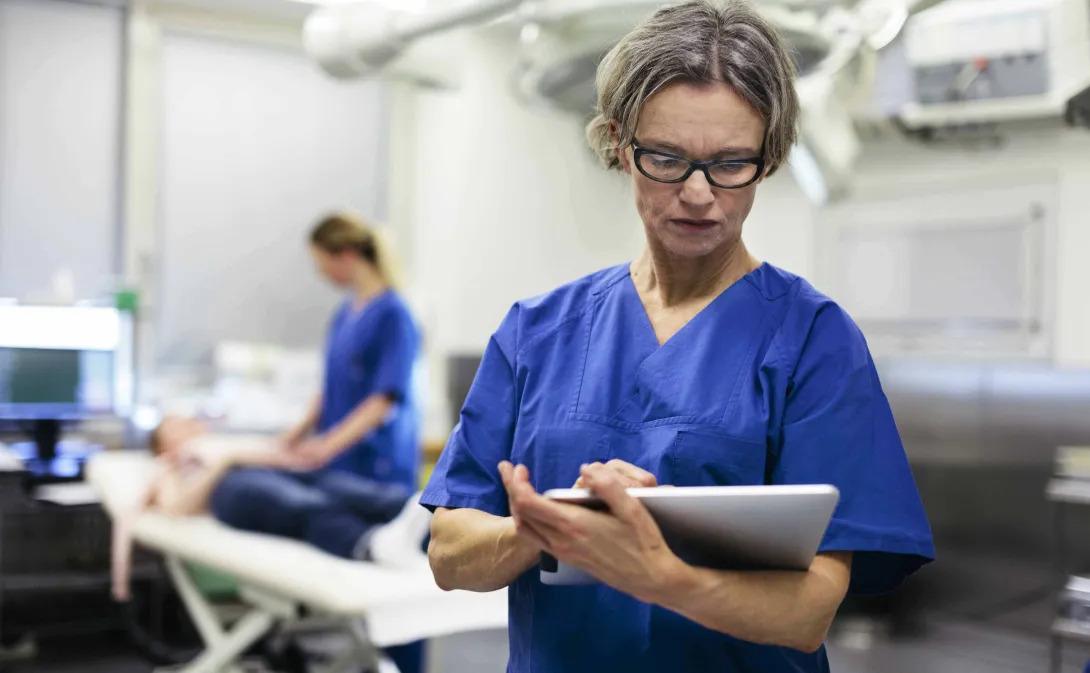 Physician uses tablet for information.