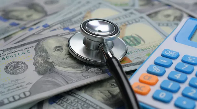 stethoscope, money and a calculator