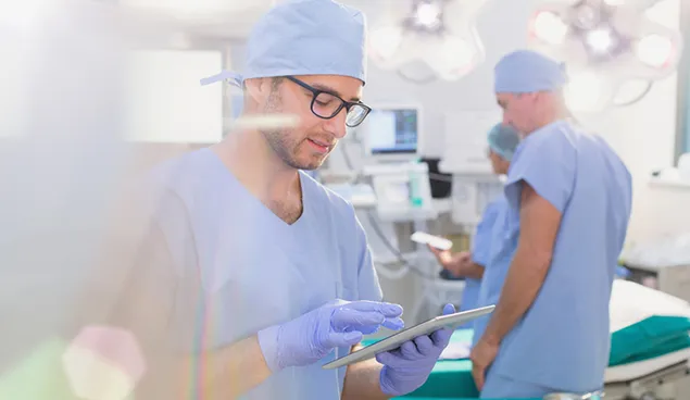 Person in scrubs with tablet