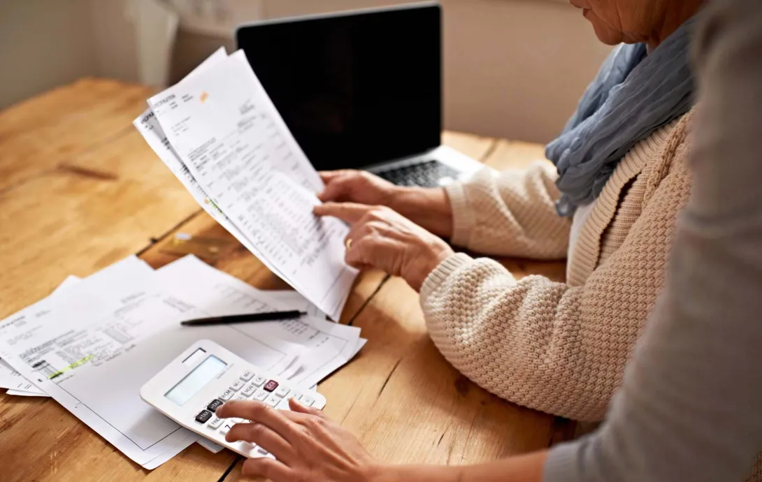 Two people go over paperwork Two people go over paperwork