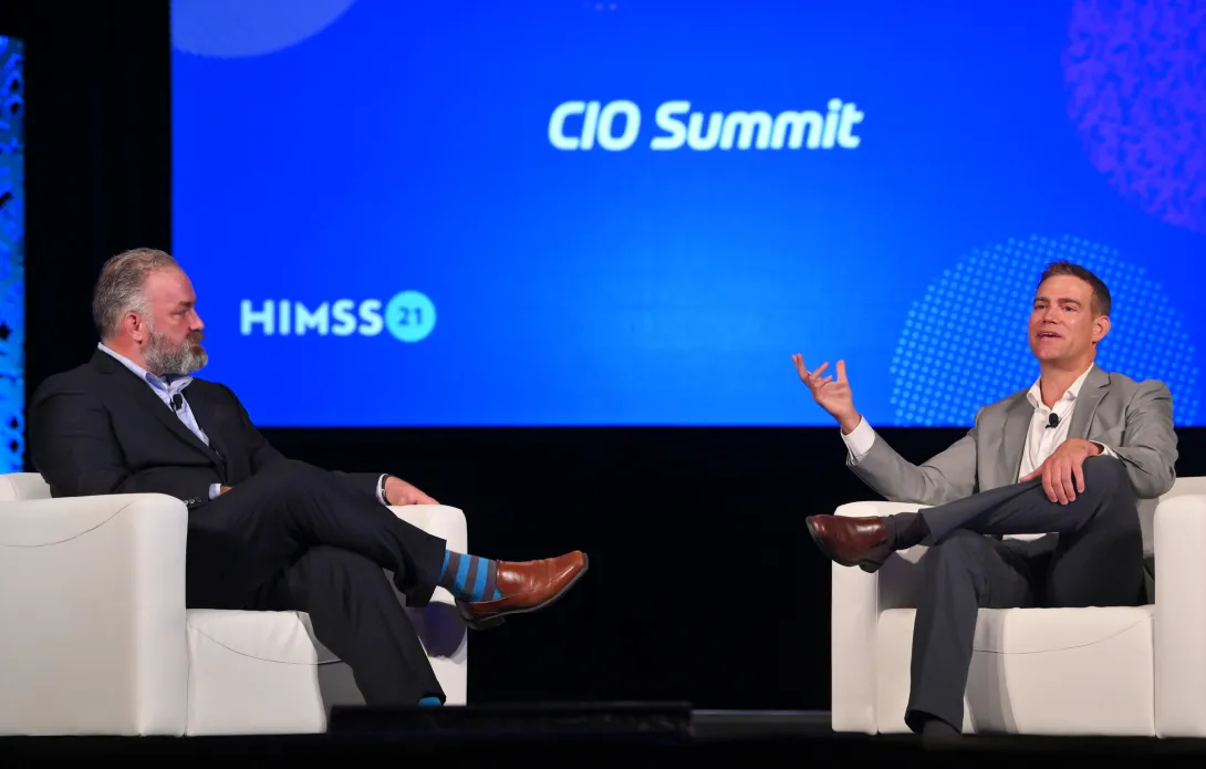 Reid Oakes, left, executive vice president of Analytics for HIMSS, talks to MLB veteran Theo Epstein about Moneyball, analytics and what they have in common with healthcare. Photo: Oscar & Associates for HIMSS
