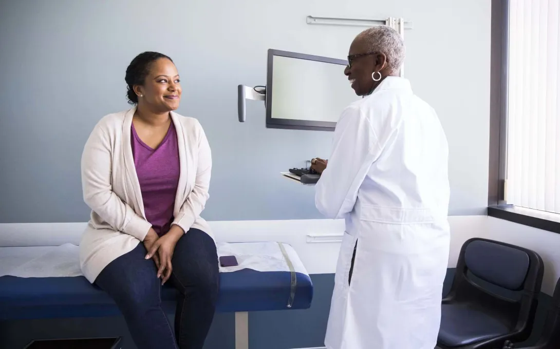 Physician talks to a patient in the office.