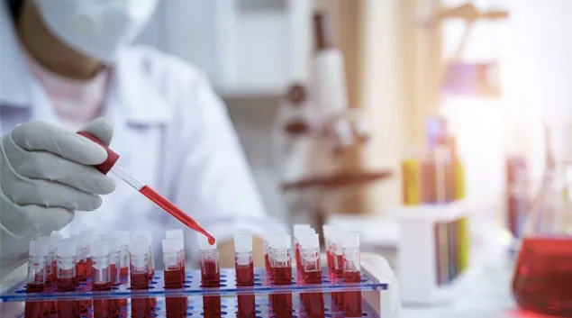 Blood samples being dropped into test tubes