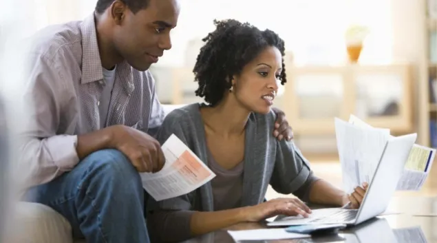 Couple looking at medical bills Couple looking at medical bills
