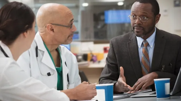 Two doctors meeting at table with executive Two doctors meeting at table with executive