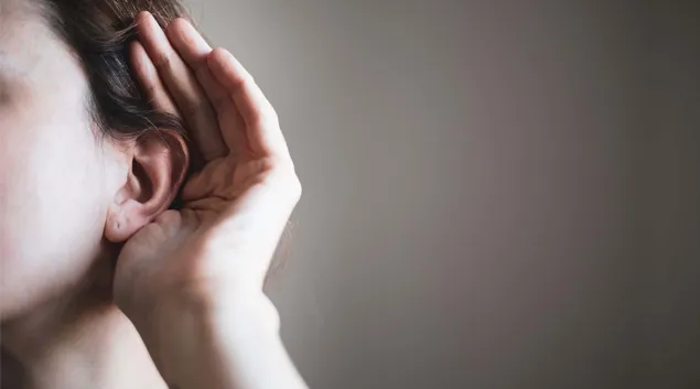 Person cupping an ear Person cupping an ear