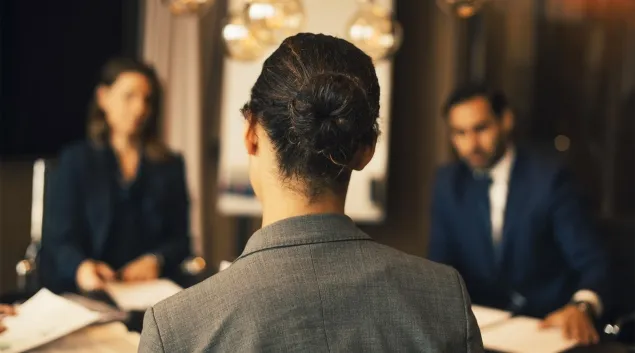 People at a conference table in discussion
