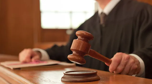 Judge in courtroom with gavel Judge in courtroom with gavel