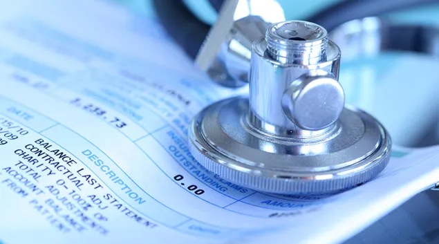 A stethoscope resting on a medical bill
