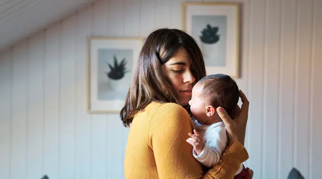 Adult holding baby Adult holding baby