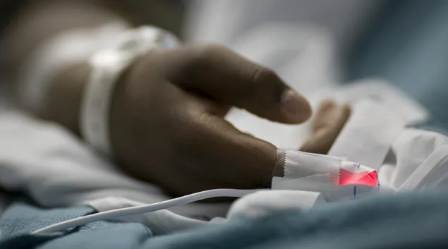 A person's hand in a hospital bed (Photo: rubberball/Getty Images)